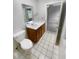 Simple bathroom with vanity, toilet and tiled floor at 5421 19Th St, Zephyrhills, FL 33542