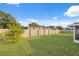 Large backyard with grassy area and wooden fence at 4406 Woodtrail Blvd, New Port Richey, FL 34653