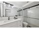 Modern bathroom with white cabinets, quartz countertop and walk-in shower at 4406 Woodtrail Blvd, New Port Richey, FL 34653