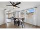 Bright dining area with a wood table and four chairs, near sliding doors at 4406 Woodtrail Blvd, New Port Richey, FL 34653