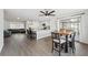 Open concept dining area with wood table and chairs, adjacent to kitchen at 4406 Woodtrail Blvd, New Port Richey, FL 34653