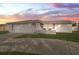 Ranch home with a white exterior, attached garage, and landscaped yard at 4406 Woodtrail Blvd, New Port Richey, FL 34653