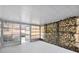 Screened Florida room with backyard access and a stone wall at 4406 Woodtrail Blvd, New Port Richey, FL 34653