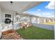 Inviting front porch with wicker chairs and a festive holiday wreath at 4406 Woodtrail Blvd, New Port Richey, FL 34653