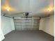 Garage with painted floor and automatic garage door opener at 4406 Woodtrail Blvd, New Port Richey, FL 34653