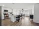 Modern kitchen with white cabinets, stainless steel appliances, and breakfast bar at 4406 Woodtrail Blvd, New Port Richey, FL 34653