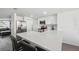 Updated kitchen with white cabinets and a large quartz island at 4406 Woodtrail Blvd, New Port Richey, FL 34653