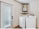 Laundry room with washer, dryer, and exterior access at 4406 Woodtrail Blvd, New Port Richey, FL 34653