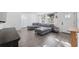 Living area featuring an L-shaped sectional sofa and hardwood floors at 4406 Woodtrail Blvd, New Port Richey, FL 34653