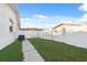 Side yard with a paved walkway and grassy area at 4406 Woodtrail Blvd, New Port Richey, FL 34653