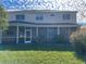 Two story house with screened porch and grassy backyard at 25737 Frith St, Land O Lakes, FL 34639