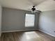 Bright bedroom featuring wood-look floors and a ceiling fan at 25737 Frith St, Land O Lakes, FL 34639