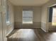 Well-lit bedroom with wood-look floors and window coverings at 25737 Frith St, Land O Lakes, FL 34639