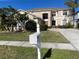 Two-story house with beige exterior, landscaping, and a white mailbox at 25737 Frith St, Land O Lakes, FL 34639
