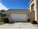 White double-car garage with a wooden pallet leaning against it at 25737 Frith St, Land O Lakes, FL 34639