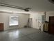 Garage with overhead door opener, storage, and water softener at 25737 Frith St, Land O Lakes, FL 34639