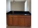 Kitchen counter with black granite top and wood cabinets at 25737 Frith St, Land O Lakes, FL 34639