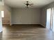 Spacious living room featuring wood-look floors and ceiling fan at 25737 Frith St, Land O Lakes, FL 34639