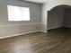 Bright living room with wood-look floors and an arched doorway at 25737 Frith St, Land O Lakes, FL 34639