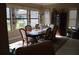 Bright dining room with large windows and elegant wooden furniture at 32026 Wenlock Loop, Wesley Chapel, FL 33543