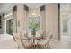 Bright breakfast nook features a round table and four chairs, offering a view of the pool at 9044 Luna Ln, Sarasota, FL 34241
