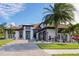 White two-story house with brown roof, palm trees, and a paved driveway at 9044 Luna Ln, Sarasota, FL 34241