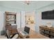 Bright home office with built-in shelving and view into the living area at 9044 Luna Ln, Sarasota, FL 34241