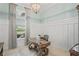 Spacious home office features a large desk, built-in shelving, and plenty of natural light at 9044 Luna Ln, Sarasota, FL 34241
