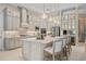 Modern kitchen with white cabinets, quartz countertops and island at 9044 Luna Ln, Sarasota, FL 34241