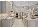 Modern kitchen with white cabinets, quartz countertops, and a large island at 9044 Luna Ln, Sarasota, FL 34241