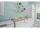 Well-lit laundry room featuring white cabinets and a large countertop at 9044 Luna Ln, Sarasota, FL 34241