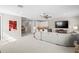 Open living area with sectional sofa, wet bar, and large TV at 9044 Luna Ln, Sarasota, FL 34241