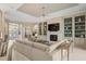 Spacious living area featuring a sectional sofa and built-in shelving at 9044 Luna Ln, Sarasota, FL 34241