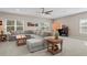 Relaxing living room featuring a large sectional sofa and ceiling fan at 9044 Luna Ln, Sarasota, FL 34241