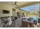 Covered patio with pool, outdoor kitchen, and dining area at 9044 Luna Ln, Sarasota, FL 34241