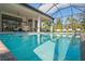 Relaxing pool with screened enclosure and lounge chairs at 9044 Luna Ln, Sarasota, FL 34241