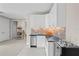 Modern wet bar with white cabinets and granite countertop at 9044 Luna Ln, Sarasota, FL 34241