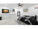 Bedroom with mounted TV and ceiling fan at 1898 New Hampshire Ne Ave, St Petersburg, FL 33703