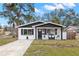 Charming remodeled home with a modern black and white exterior, and a spacious front yard at 1898 New Hampshire Ne Ave, St Petersburg, FL 33703