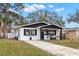 Cute bungalow with a newly paved driveway and a well manicured lawn at 1898 New Hampshire Ne Ave, St Petersburg, FL 33703