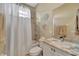 Bathroom with tub shower, vanity, and window at 7 Barge Ln, Placida, FL 33946