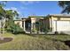 House exterior featuring a tan, two-car garage home with manicured landscaping at 7 Barge Ln, Placida, FL 33946