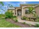 Front entryway with lush landscaping and a double door entry to the home at 7 Barge Ln, Placida, FL 33946