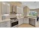 Modern kitchen with stone backsplash and stainless steel appliances at 7 Barge Ln, Placida, FL 33946