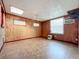 Spacious basement room with wood paneling and window at 70 Horton Cir, Sarasota, FL 34232