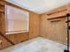 Unfinished basement room with wood paneling at 70 Horton Cir, Sarasota, FL 34232