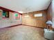 Bright basement room with wood paneling and skylight at 70 Horton Cir, Sarasota, FL 34232