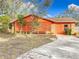 Cute orange house with a carport and a partially fenced yard at 70 Horton Cir, Sarasota, FL 34232