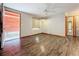 Living room with hardwood floors, ceiling fan, and exterior access at 70 Horton Cir, Sarasota, FL 34232