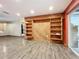 Living room with wood-paneled wall and built-in shelving at 70 Horton Cir, Sarasota, FL 34232